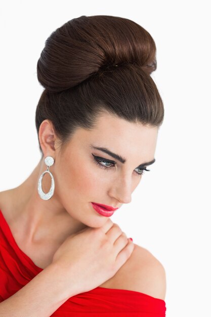 Woman looking down while wearing a red dress