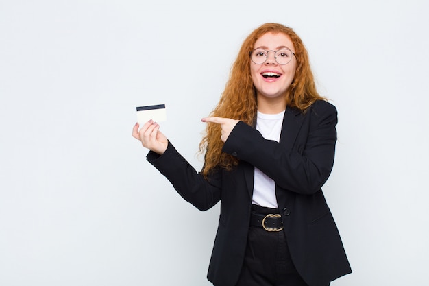 woman looking excited and surprised pointing to the side and upwards to copy space