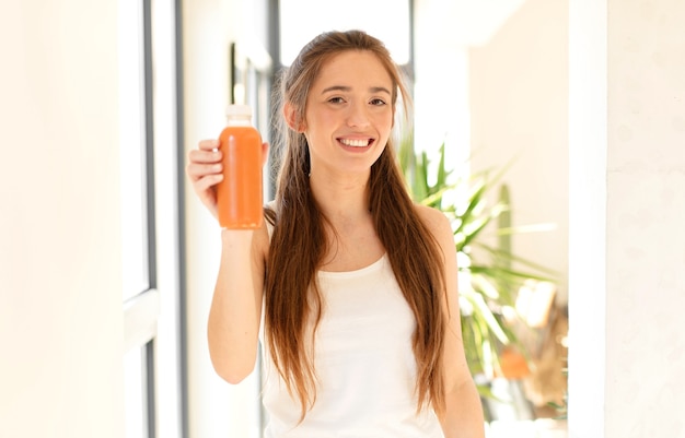 Photo woman looking happy and pleasantly surprised, excited with a fascinated and shocked expression