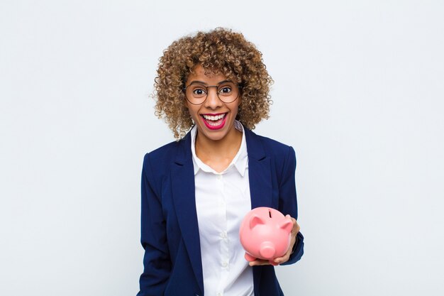 woman looking happy and pleasantly surprised, excited with a fascinated and shocked expression