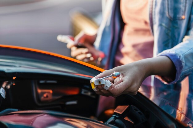 Woman looking at her car to solve a problem