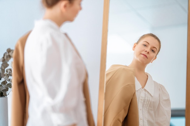 woman looking at her reflection in mirror