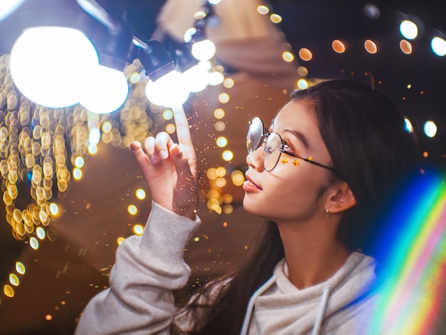 woman looking at illuminated lighting equipment at night