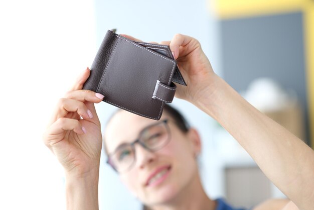 Woman looking into an empty wallet closeup