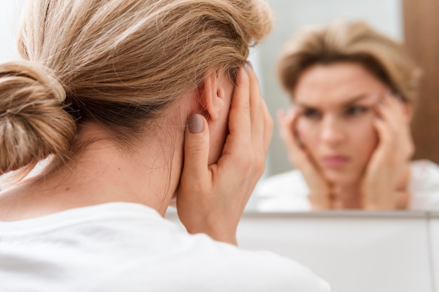 Woman looking into the mirror blurred reflection