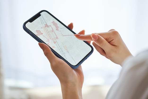 A woman looking at a map on a smartphone