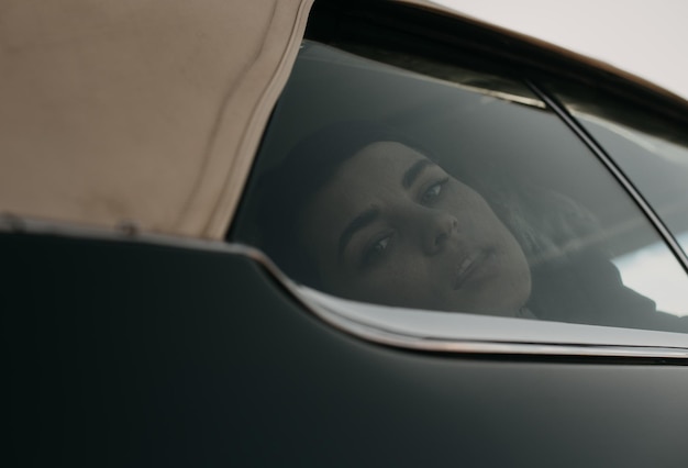 A woman looking out of a car window