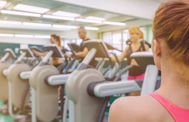 Woman looking at people exercising in gym