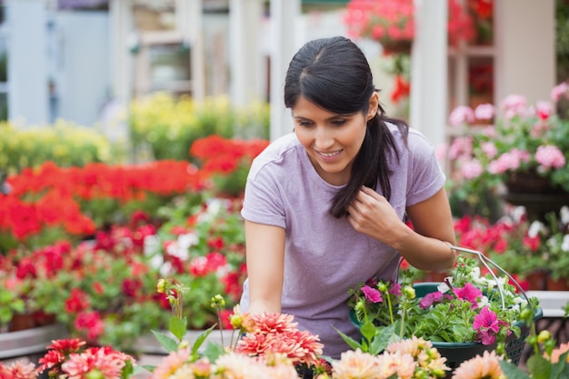 Woman looking at plants in garden center