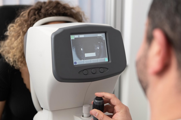 Woman Looking at Refractometer Eye Test Machine in Ophthalmology