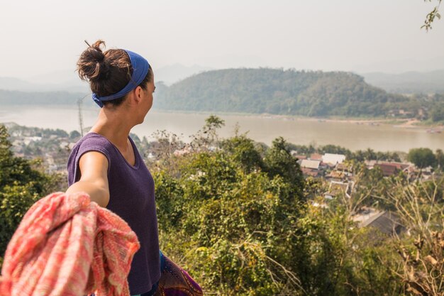 Woman looking to the river in Laos, Asia.