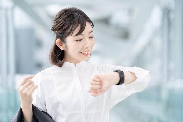 A woman looking at a smartwatch on her wrist