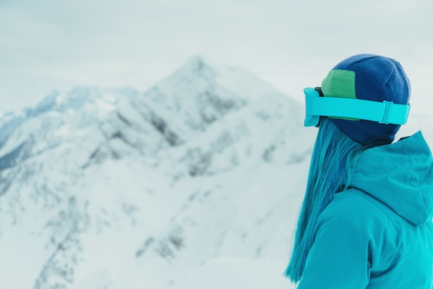 Woman looking at snowy mountains