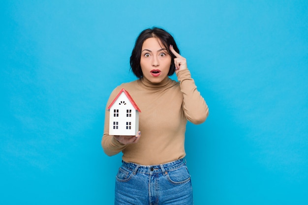 woman looking surprised, open-mouthed, shocked, realizing a new thought, idea or concept