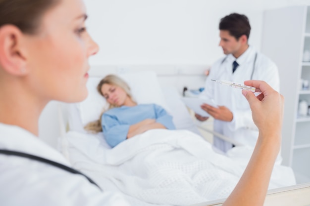 Woman looking at thermometer