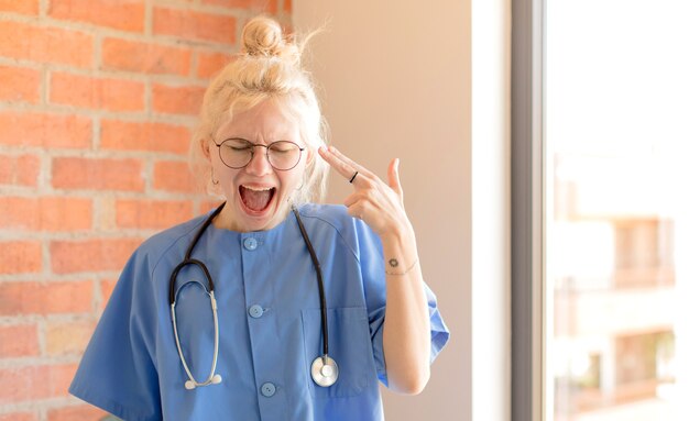 woman looking unhappy and stressed, suicide gesture making gun sign with hand, pointing to head