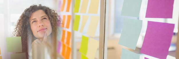 Woman looking up at sticky notes and sticky note transition