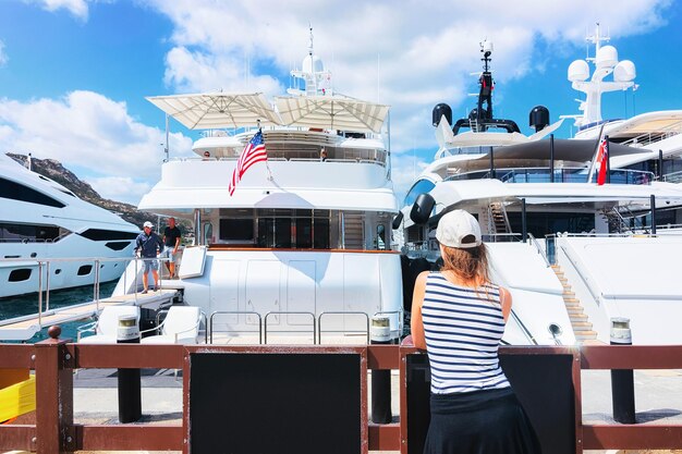 Woman looking at the yachts in Porto Cervo, Costa Esmeralda, Sardinia, Italy.