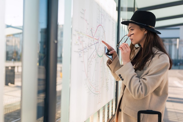 Woman looks at the city map