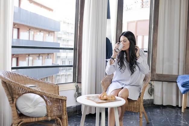 Photo woman looks out a hotel window