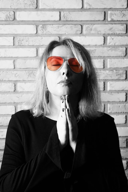 The woman looks through rosecolored glasses black and white photo with an emphasis on pink glasses