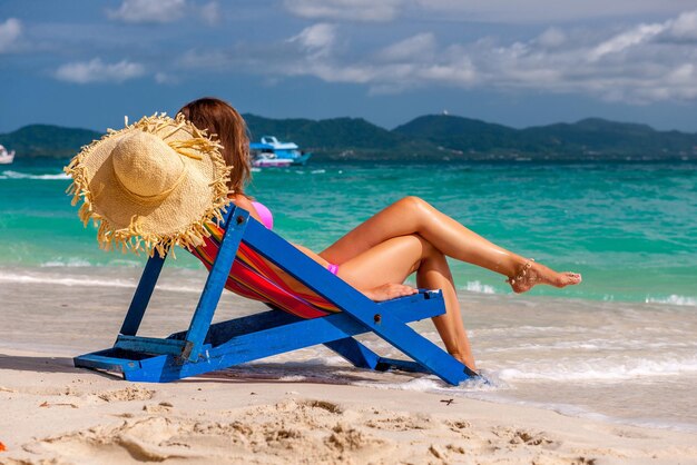 Woman in lounger on tropical beach