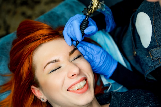 Woman lying on couch at beauty salon with closed eyes and grinning.