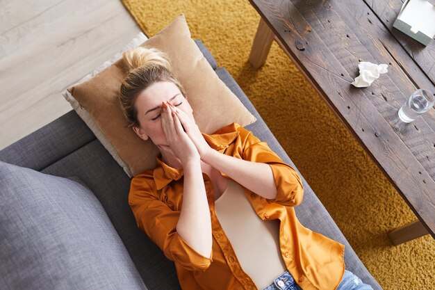 Woman lying on couch and crying at therapy session