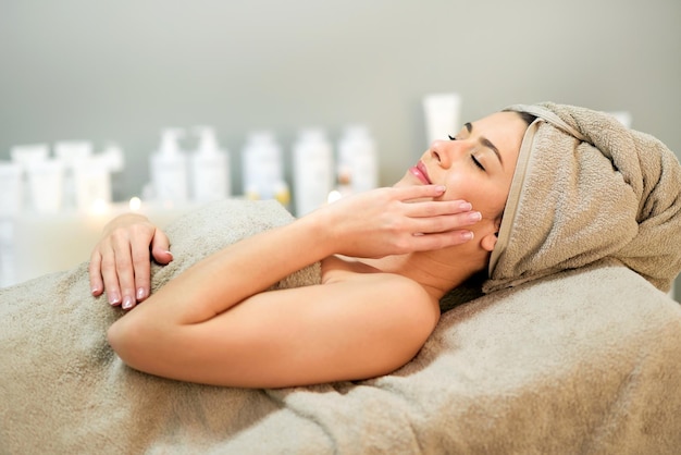 Woman lying on couch in spa center