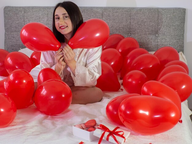 Woman lying in decorations with balloons for Valentines Day party