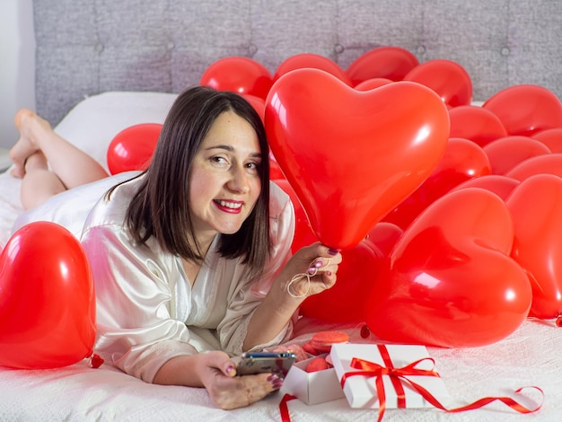 Woman lying in decorations with balloons for Valentines Day party