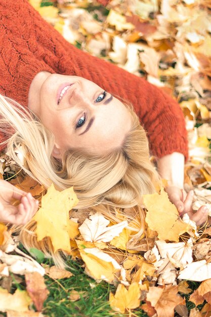 Woman lying down on yellow leaves