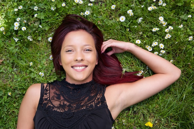 Woman lying on grass and smiling