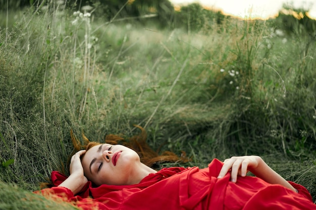 Woman lying on grassy field