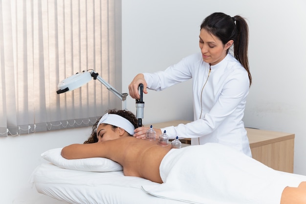 Woman lying on her chest with cupping treatment on her back. woman doing sucker