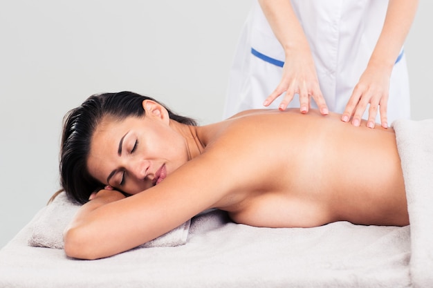 Woman lying on massage lounger