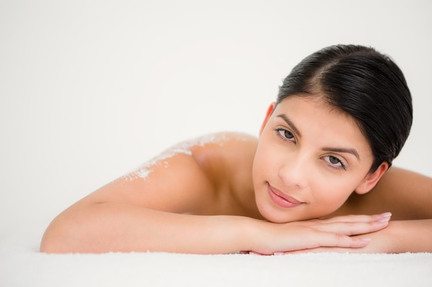 Woman lying with salt scrub on the back