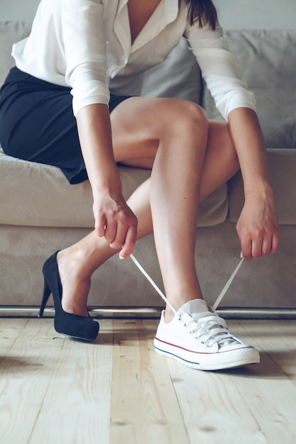 Woman makes the choice between comfortable and uncomfortable\
shoes.