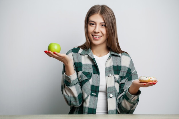 Woman makes a choice between healthy and harmful food