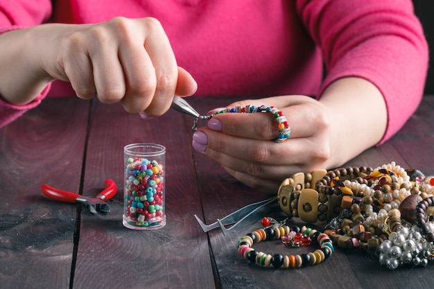 Woman makes craft beads