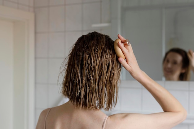 Woman makes a head self massage for hair growth