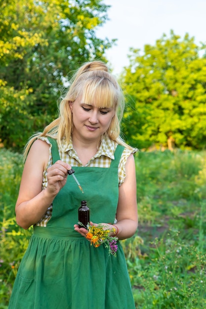 A woman makes herbal tincture Selective focus