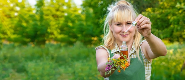 A woman makes herbal tincture Selective focus