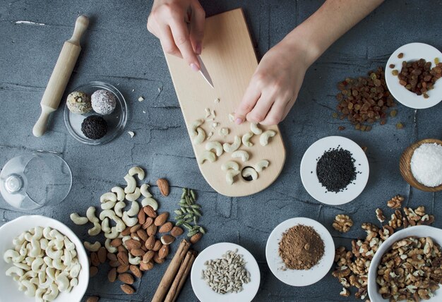 woman makes natural candies from nuts and dried fruits at home top view