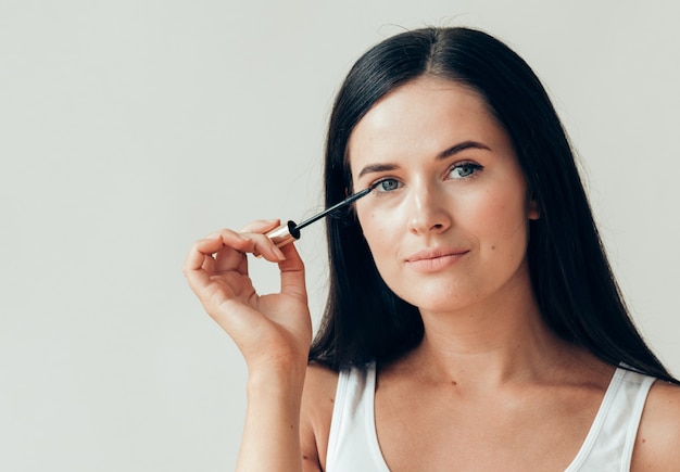 Woman makeup mascara eyes healthy skin natural fashion makeup. Studio shot.