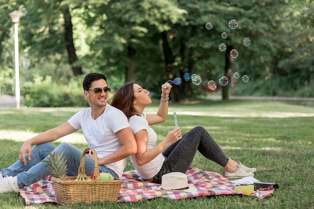 Woman making bubbles at picnic