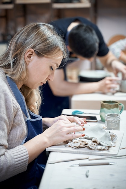 Woman making ceramic pottery on workshop. Concept for woman in freelance, business. Handcraft