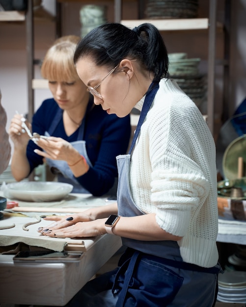 Woman making ceramic pottery.