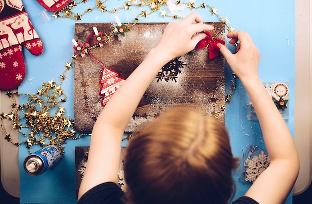 Foto donna che fa la decorazione natalizia a casa