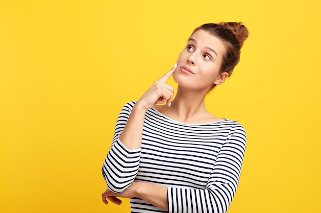 woman making faces against yellow